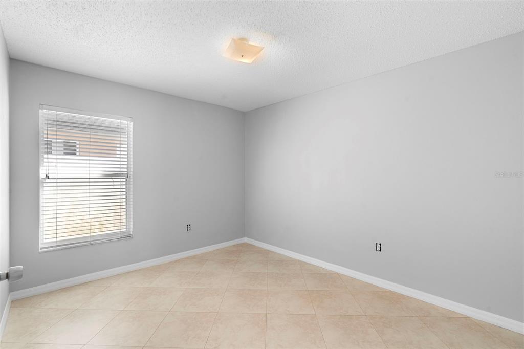 559 Saddle Ridge Drive Davenport, FL 33896 - Photo 25 of 42 a view of an empty room with a window