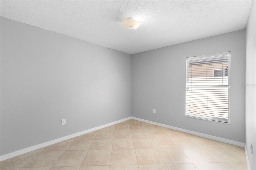 559 Saddle Ridge Drive Davenport, FL 33896 - Photo 26 of 42 a view of an empty room with a window