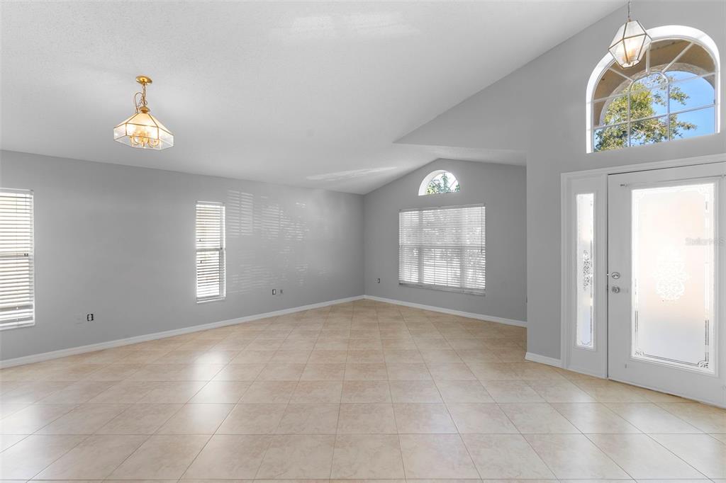 559 Saddle Ridge Drive Davenport, FL 33896 - Photo 28 of 42 an empty room with windows and wooden floor
