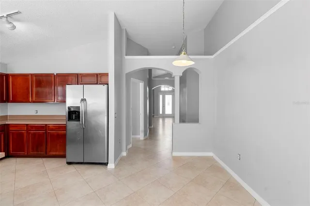 a kitchen with stainless steel appliances granite countertop a sink stove refrigerator and cabinets