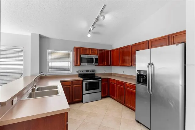a open kitchen with cabinets and stainless steel appliances