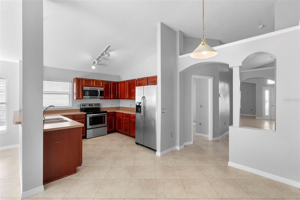 559 Saddle Ridge Drive Davenport, FL 33896 - Photo 38 of 42 a open kitchen with cabinets and stainless steel appliances