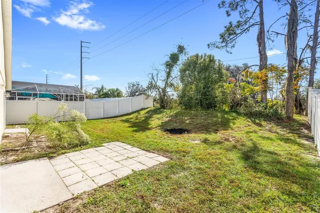 a view of a house with pool and a yard
