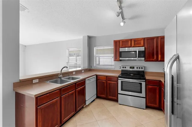 a kitchen with a sink and a stove top oven