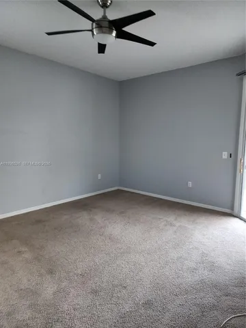 a view of a big room with a ceiling fan