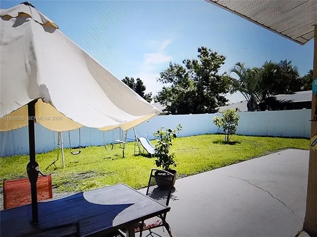 a view of a chairs and table in patio