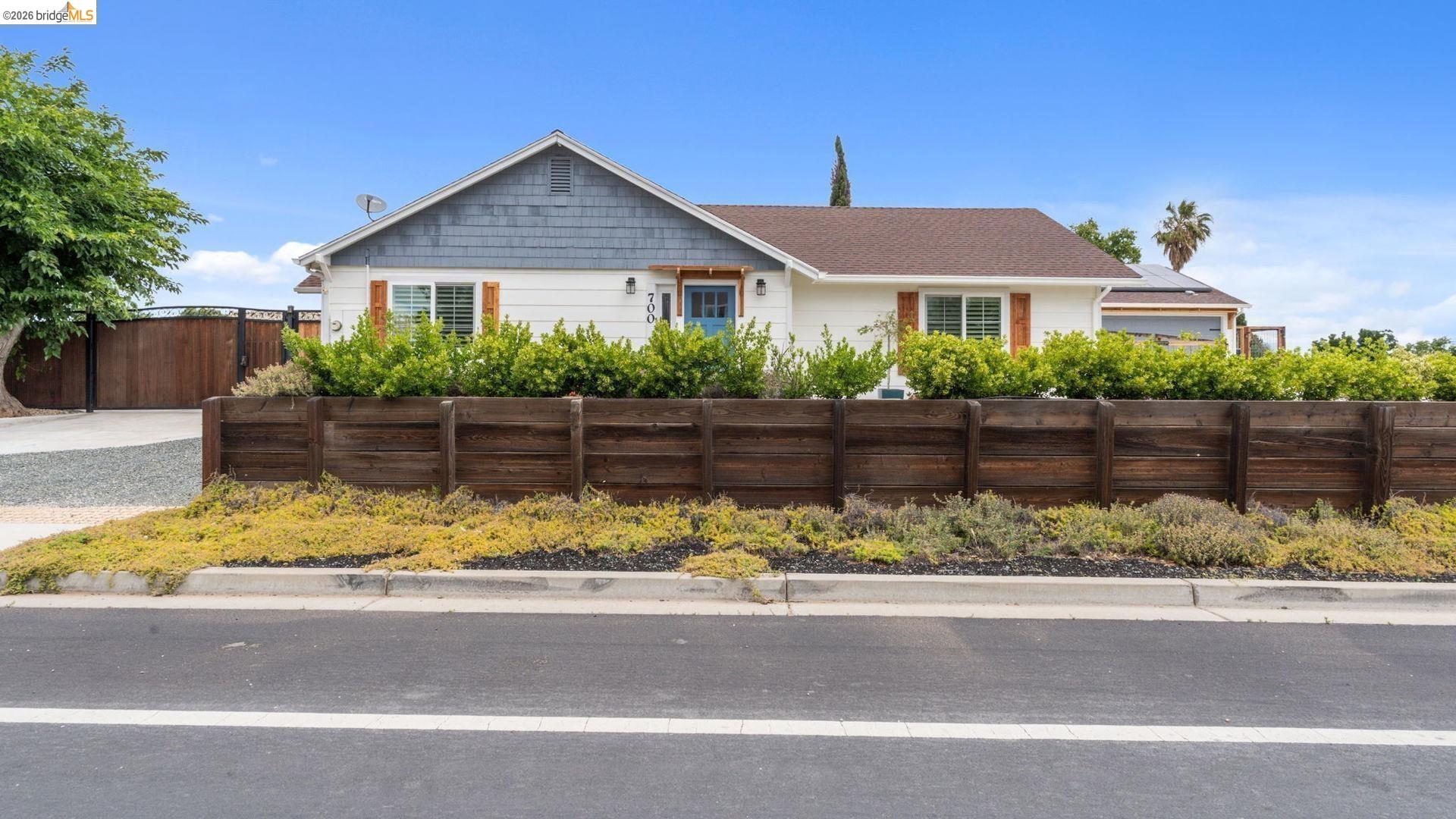 700 Brownstone Road Oakley, CA 94561 - Photo 55 of 58 White exterior with gray shake siding and a brown shingle roof