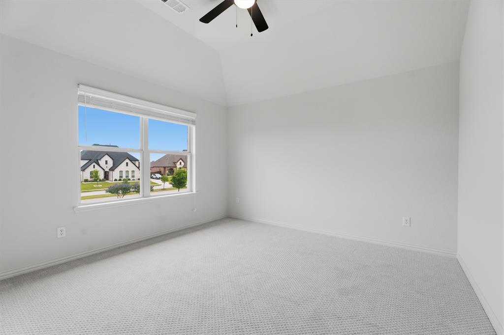 1316 Limestone Ridge Road Mansfield, TX 76063 - Photo 25 of 40 Spacious room featuring vaulted ceilings, a ceiling fan, light gray carpet flooring, and a large window with white blinds