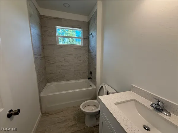 a bathroom with a sink toilet and bathtub