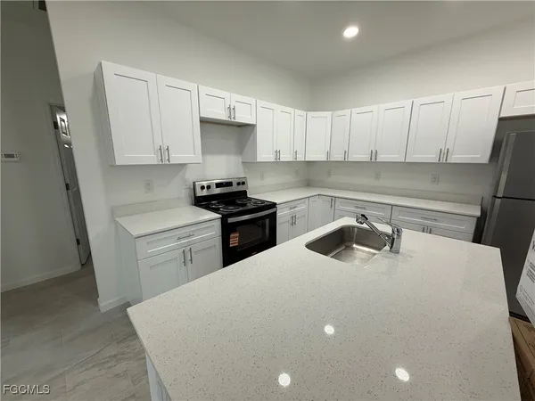 a kitchen with a sink a stove and refrigerator