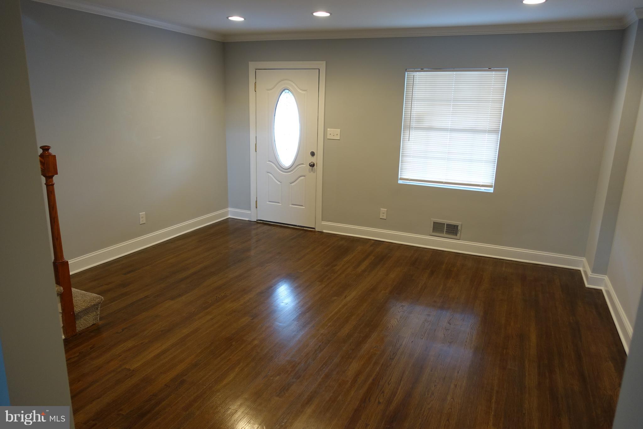 338 Grovethorn Road Baltimore, MD 21220 - Photo 2 of 24 an empty room with wooden floor and windows