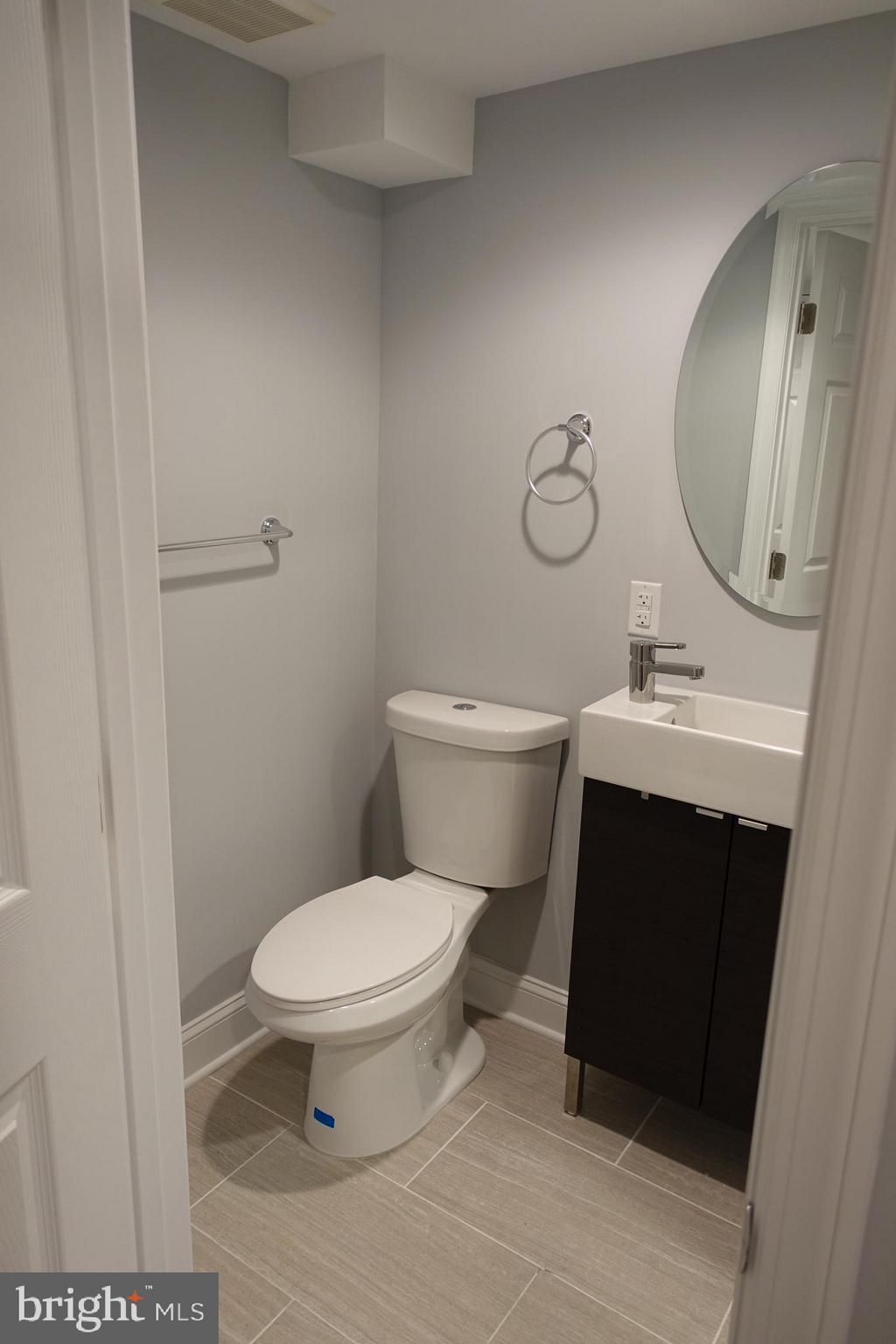 338 Grovethorn Road Baltimore, MD 21220 - Photo 19 of 24 a bathroom with a toilet a sink and mirror