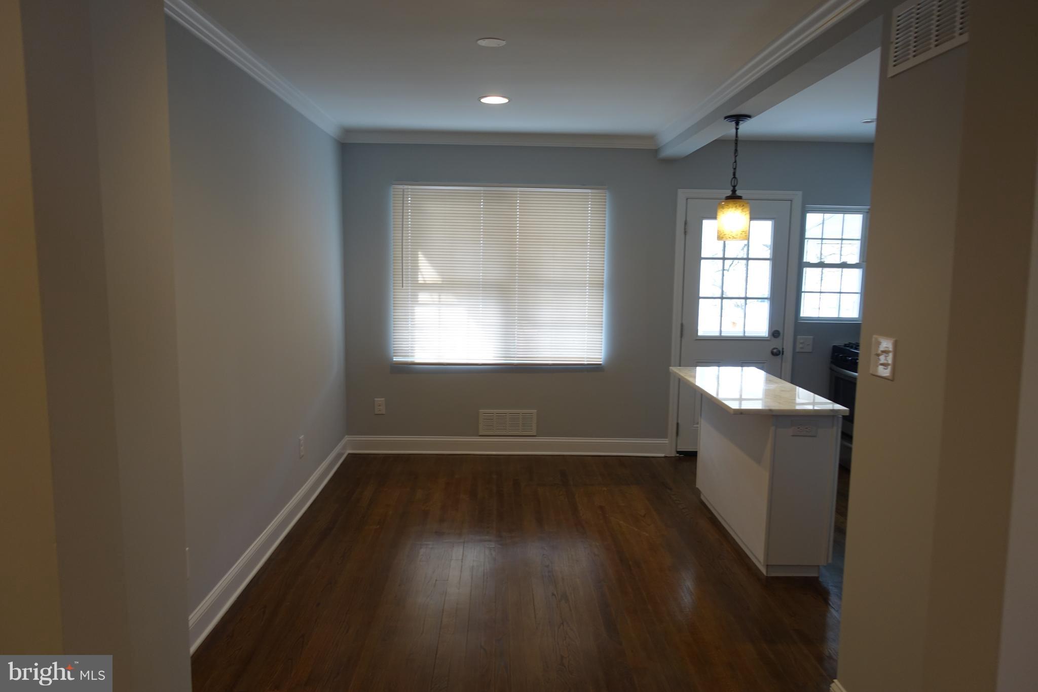 338 Grovethorn Road Baltimore, MD 21220 - Photo 7 of 24 an empty room with wooden floor and windows