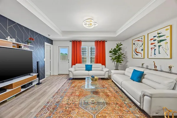 a living room with furniture and a flat screen tv