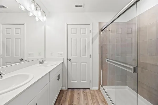 a bathroom with a double vanity sink and mirror