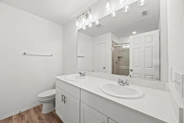 a bathroom with a toilet a sink and mirror