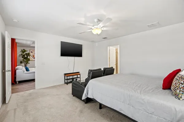 a bedroom with a bed and a flat screen tv