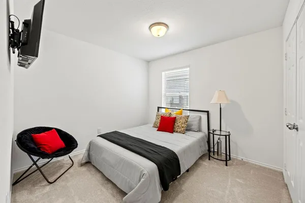 a bedroom with a bed and a chandelier