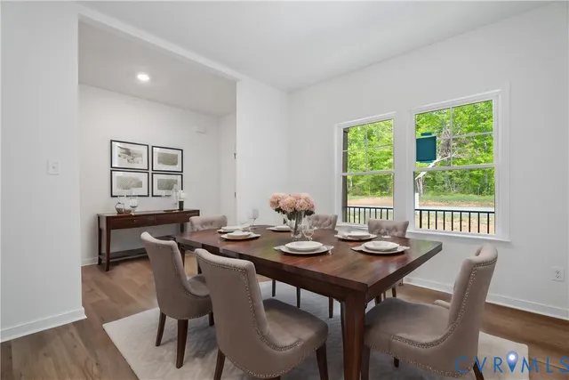 a kitchen with a table chairs sink microwave and cabinets