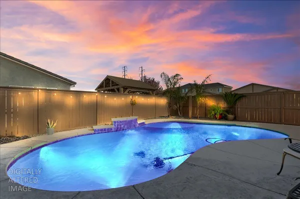 a view of a swimming pool with a yard
