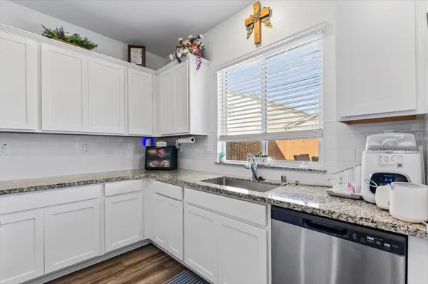 a kitchen with stainless steel appliances granite countertop a stove a microwave and a refrigerator
