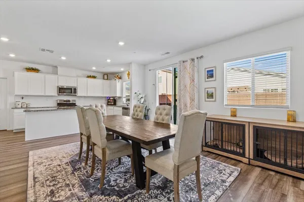 a view of a dining room with furniture window and wooden floor