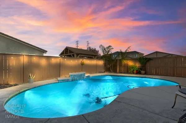 a view of a swimming pool with an outdoor seating and a tub