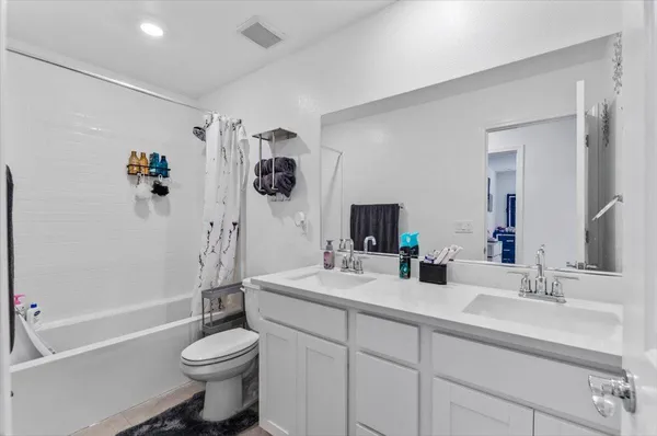 a bathroom with a double vanity sink a mirror a glass door a shower and vanity