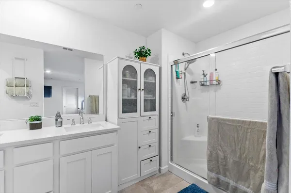 a bathroom with a sink mirror and vanity