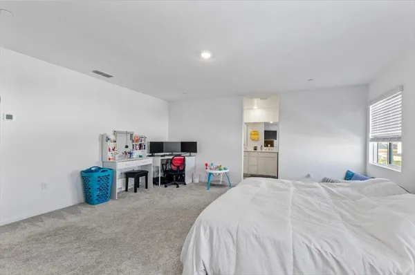 a bedroom with a bed and a flat tv screen