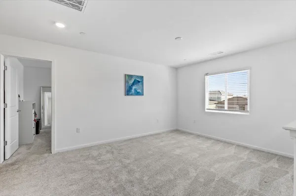 an empty room with a kitchen