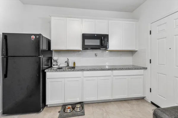 a bathroom with a sink vanity mirror and toilet