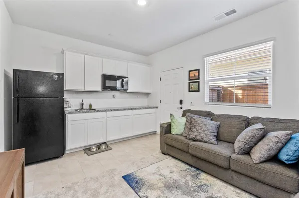 a bedroom with a bed and a flat tv screen on a dresser