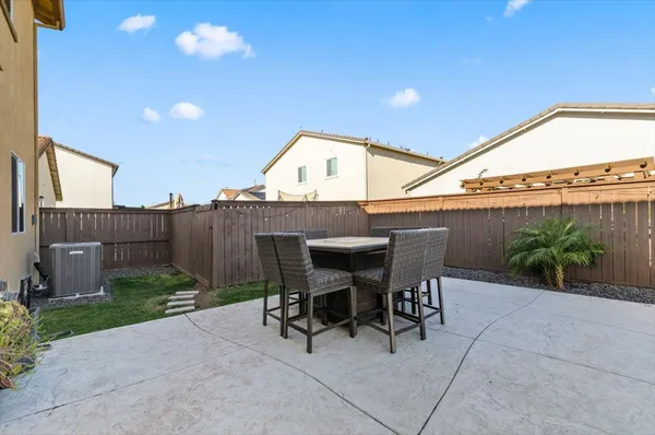 a swimming pool with outdoor seating and yard