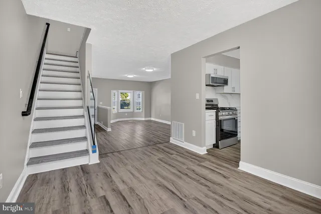 a kitchen with stainless steel appliances granite countertop a refrigerator and a window