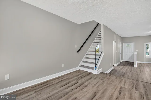 a kitchen with stainless steel appliances white cabinets a sink stove and microwave