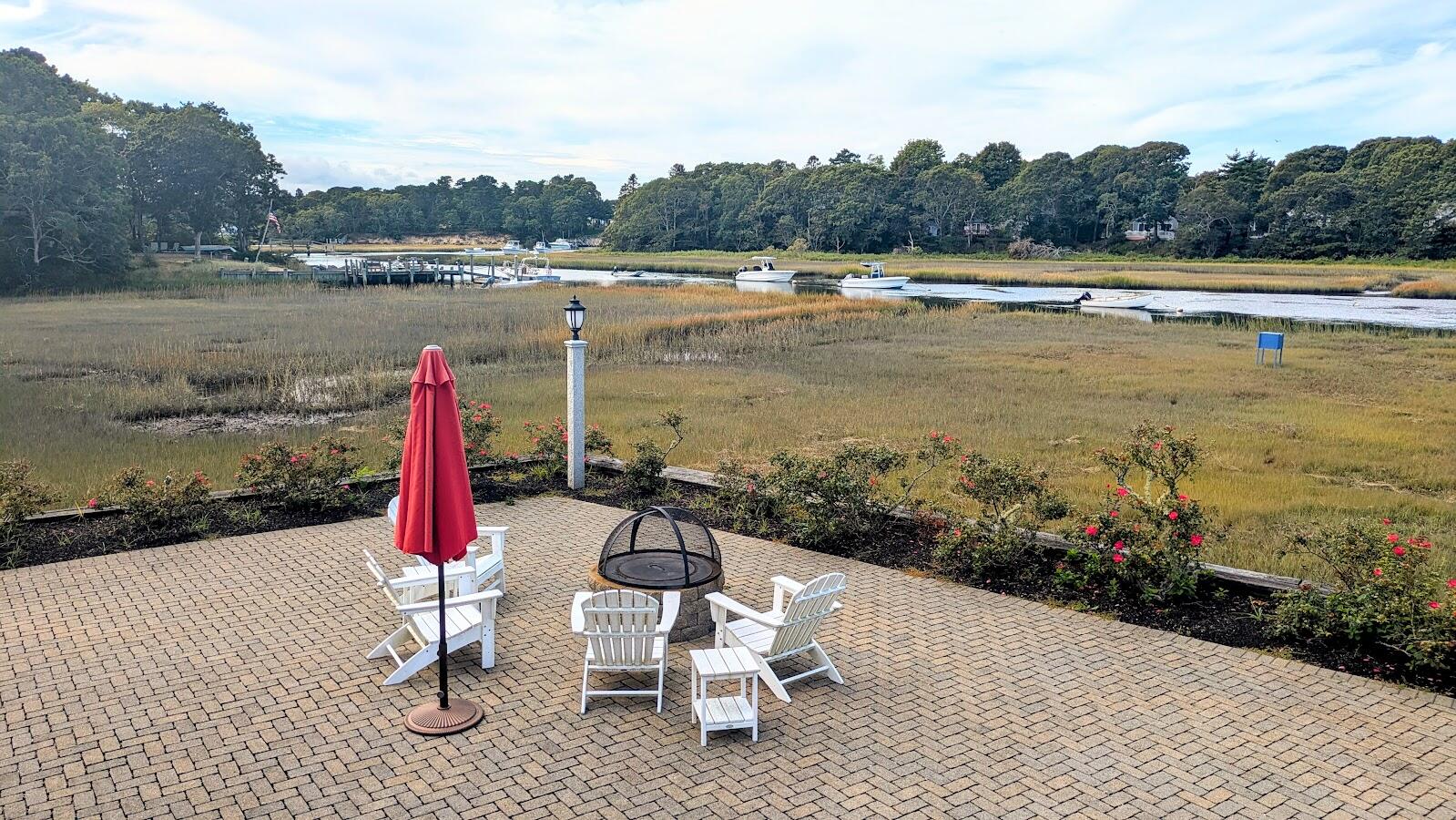 161 Route 28, Unit 7 Harwich, MA 02671 - Photo 13 of 17 a view of a lake with a table and chair