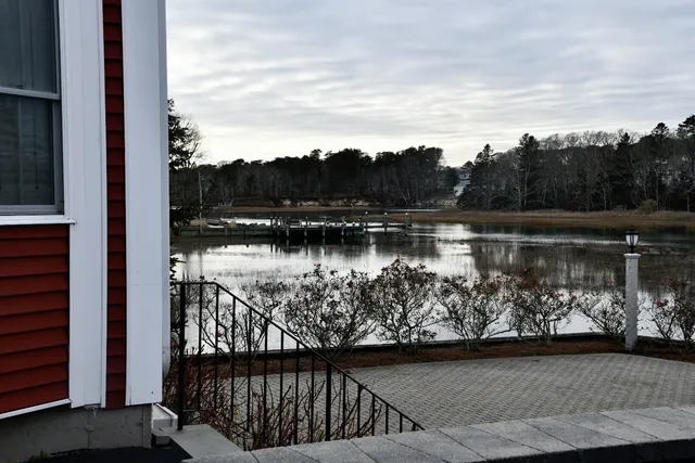 a view of a lake with a table and chair