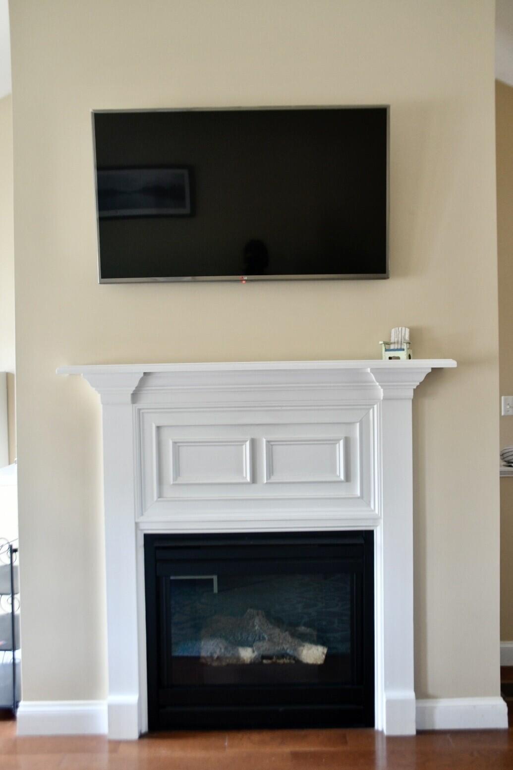 161 Route 28, Unit 7 Harwich, MA 02671 - Photo 6 of 17 a living room with a fireplace and a flat screen tv
