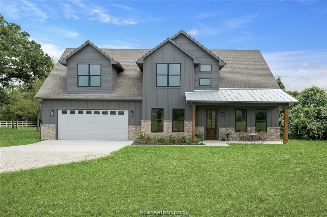 13291 Hopes Creek Road College Station, TX 77845 - Photo 5 of 45 Modern farmhouse style home with concrete driveway, a shingled roof, board and batten siding, and brick siding