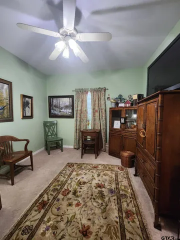 a bedroom with furniture and a flat screen tv