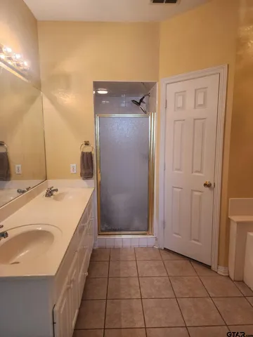 a bathroom with a bathtub and shower