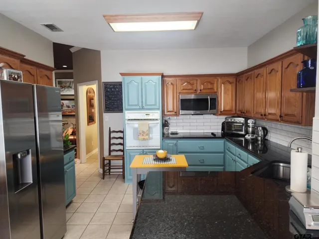 a kitchen with a refrigerator and cabinets