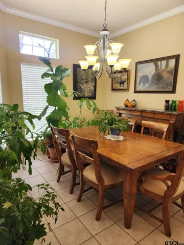 a view of a dining room with furniture and a chandelier