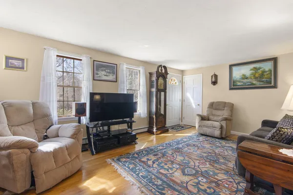 a living room with furniture and a flat screen tv