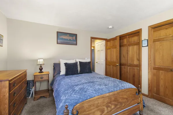 a bedroom with a bed and a table in it