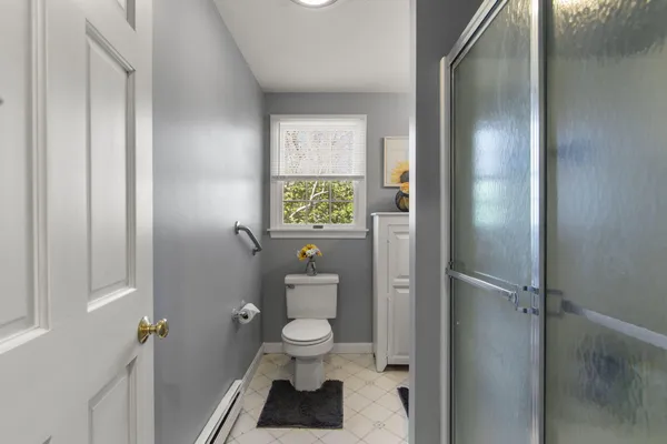 a bathroom with a toilet and a shower