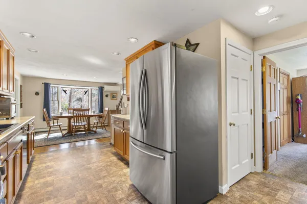 a kitchen with stainless steel appliances granite countertop a refrigerator and a sink