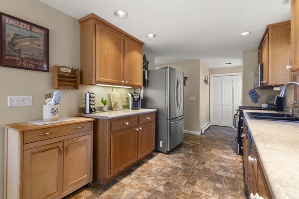 a kitchen with stainless steel appliances granite countertop a refrigerator stove and sink