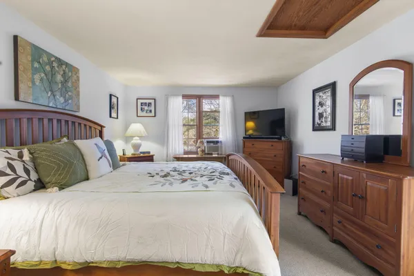 a bedroom with a large bed and a flat screen television